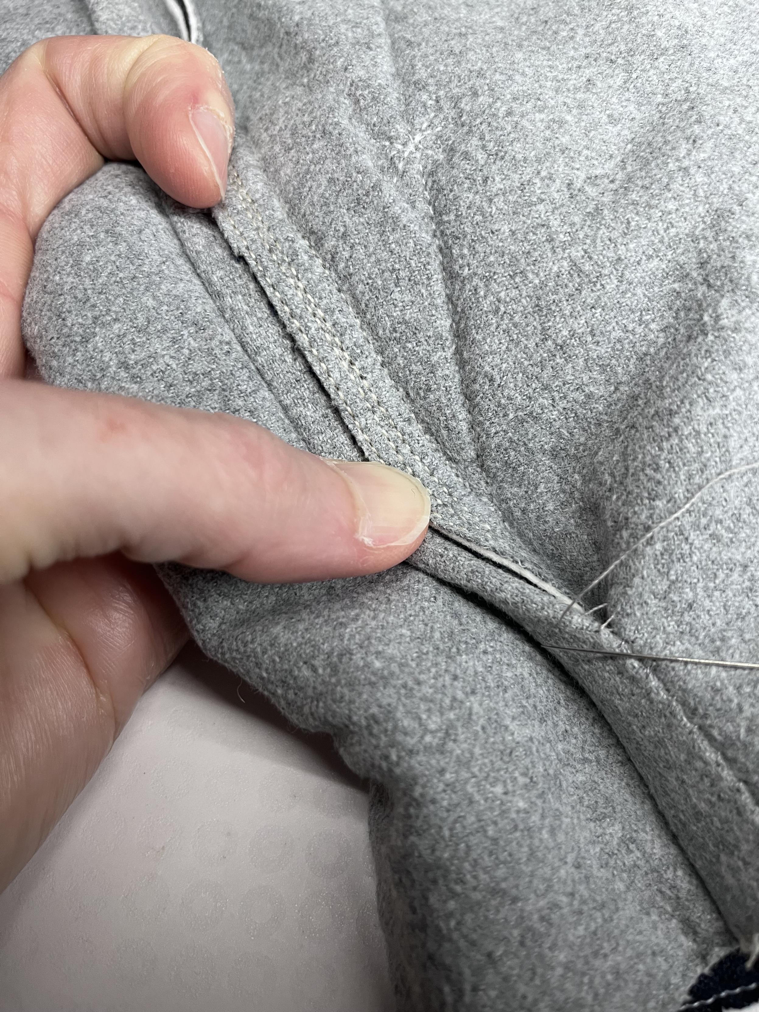 The same seam allowance is now flipped over to show the longer side, where two lines of stitching can be seen (one for the shorter edge and one for the longer).