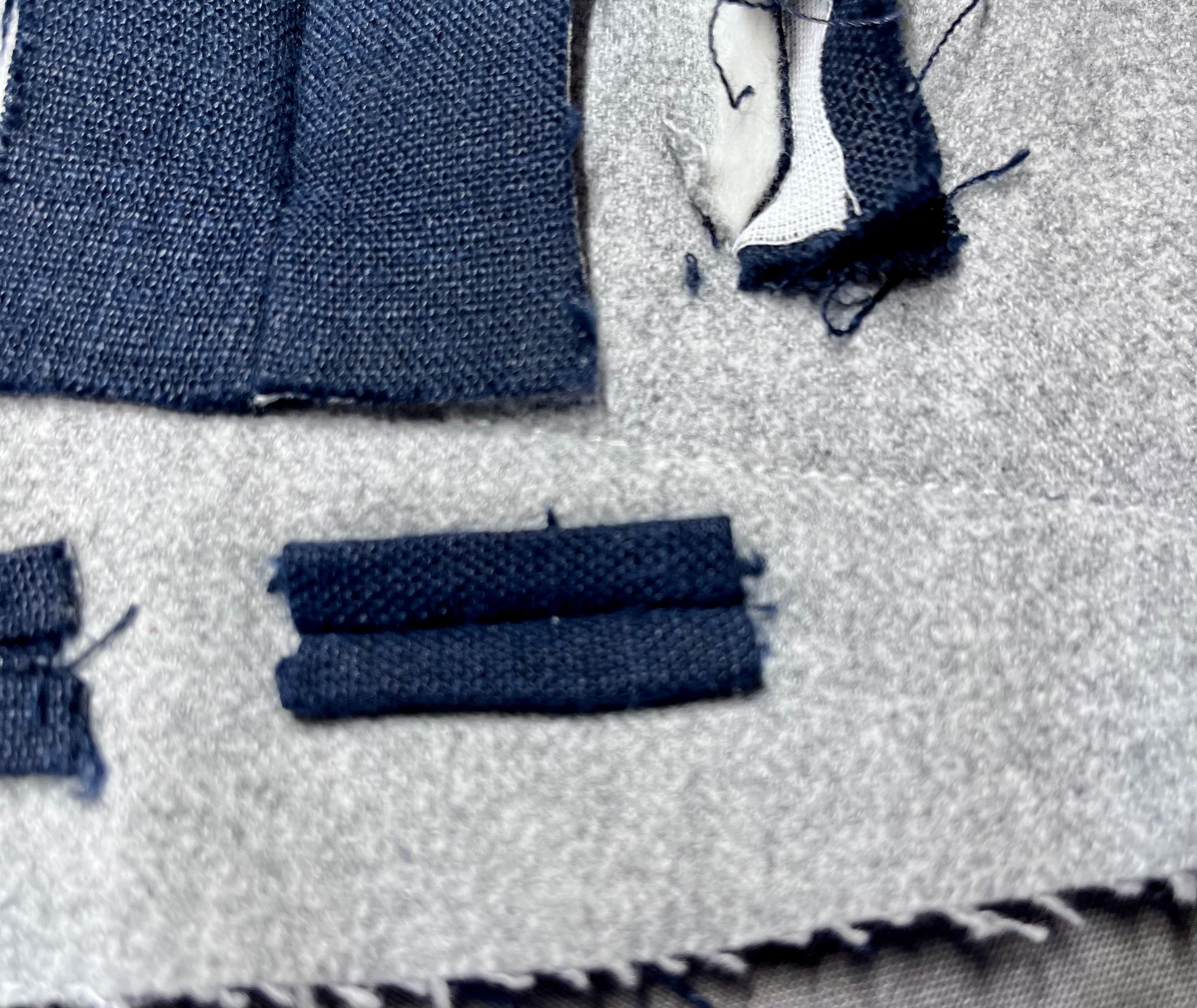 The back of that same buttonhole, with the edges folded in on all sides and quite reasonably tidy. I didn’t actually stitch the edges down because at this point my will to live had fully left my body, but it would be a nice finish if I had.
