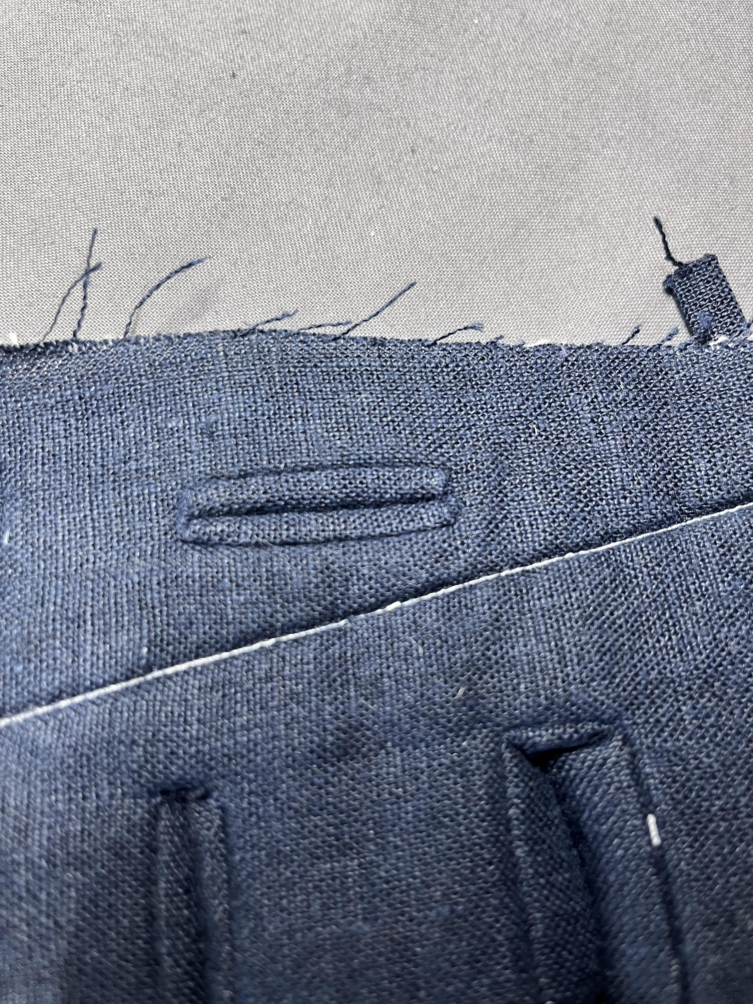The front side of a single, nicely finished, 1/4” high bound buttonhole.